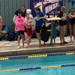 Andrew Sanders and Liam Kiessling speaking to Glacier Swim Club coach Josiah Loseby after a race at this years Alaska Swimming State Championship in Anchorage. (Courtesy Photo / Savona Kiessling)