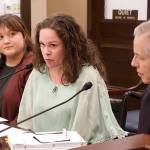 Angela Harris (center) gives testimony Wednesday on Senate bill 53 to the House Judiciary Committee while she sits next to the bills sponsor, Sen. Matt Claman, an Anchorage Democrat (right) and a member of his staff, Emma Potter (left) Harris survived a stabbing by a known offender who was released because of his incompetence to face criminal charges. (Mark Sabbatini / Juneau Empire)