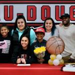 Loved ones pose with Kiyara Miller on Wednesday after she signed to play basketball at Peninsula College. From left: Bodhi Nelson, Kitalia Miller, Karen Carlos, Kiyara Miller, Kiosiyan Miller, Laura Cordero, Myron Speller and Kimari Miller. (Klas Stolpe / Juneau Empire)