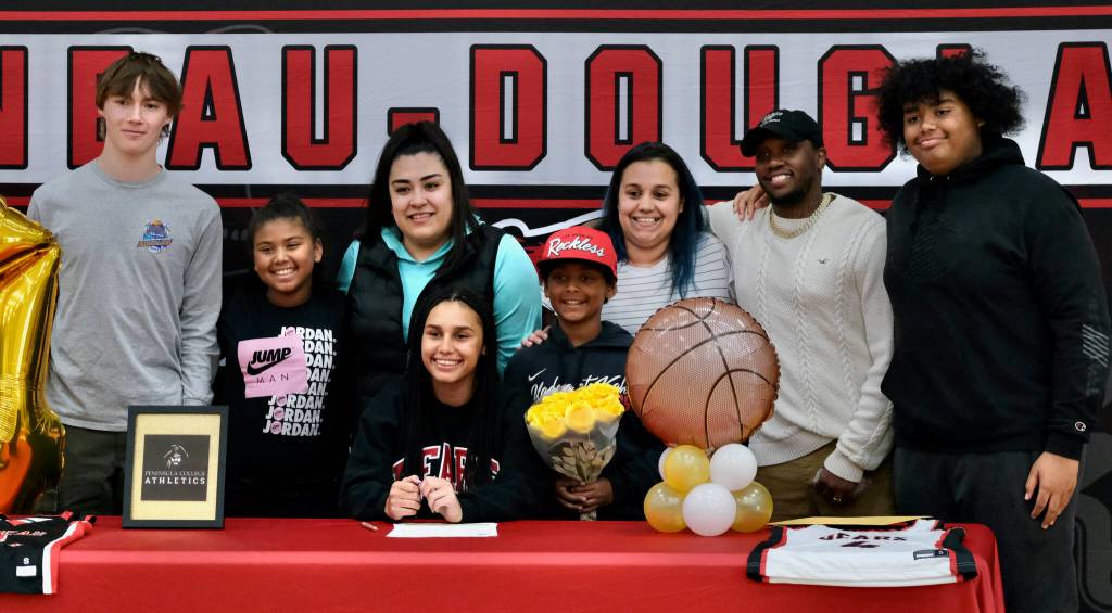 Loved ones pose with Kiyara Miller on Wednesday after she signed to play basketball at Peninsula College. From left: Bodhi Nelson, Kitalia Miller, Karen Carlos, Kiyara Miller, Kiosiyan Miller, Laura Cordero, Myron Speller and Kimari Miller. (Klas Stolpe / Juneau Empire)