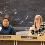 City and Borough of Juneau Assembly member Waahlaal Giidaak Barbara Blake (left) fans herself while sitting next to Carole Triem (right) during a warm Assembly Finance Committee meeting Wednesday evening. The City and Borough of Juneau narrowly approved funding for a plan that could offer up to six weeks of paid-parental leave to city employees. (Clarise Larson / Juneau Empire)