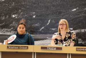 City and Borough of Juneau Assembly member Waahlaal Giidaak Barbara Blake (left) fans herself while sitting next to Carole Triem (right) during a warm Assembly Finance Committee meeting Wednesday evening. The City and Borough of Juneau narrowly approved funding for a plan that could offer up to six weeks of paid-parental leave to city employees. (Clarise Larson / Juneau Empire)
