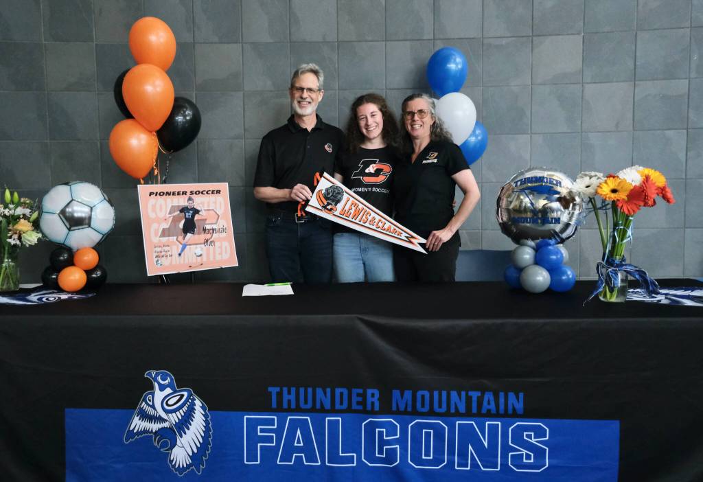 Mackenzie Olver, with parents Barry and Stacy Olver, after signing a national letter of intent on Thursday in the Thunder Mountain commons, to play soccer and study at Lewis & Clark College in Portland, Oregon. (Klas Stolpe / Juneau Empire)