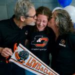 Mackenzie Olver is kissed by parents Barry and Stacy after signing a national letter of intent on Thursday in the Thunder Mountain commons, to play soccer and study at Lewis & Clark College in Portland, Oregon. (Klas Stolpe / Juneau Empire)