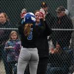 Thunder Mountain junior Ashlyn Gates (5) is congratulated by Lady Falcons coach Barb Strong after a triple during their 11-3 win over the Sitka Lady Wolves, Thursday, at Dimond Park. (Klas Stolpe / Juneau Empire)