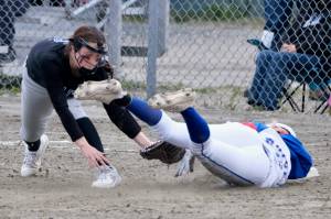 Thunder Mountain junior Ashlyn Gates (5) is congratulated by Lady Falcons coach Barb Strong after a triple during their 11-3 win over the Sitka Lady Wolves, Thursday, at Dimond Park. (Klas Stolpe / Juneau Empire)