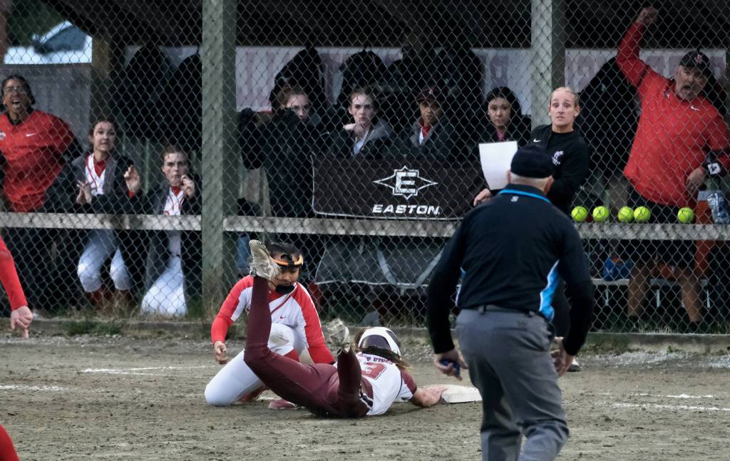 Ketchikan sophomore Mylee Gray is tagged out by Juneau-Douglas High School: Yadaa.at Kalé sophomore third baseman Milina Mazon during the Lady Kings and Crimson Bears tie on Thursday at Melvin Park. (Klas Stolpe / Juneau Empire)