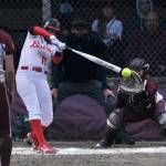 Juneau-Douglas High School: Yadaa.at Kalé senior Mariah Schauwecker (11) hits a pitch off Ketchikan junior Marley Lewis (3) as senior catcher Faith Easterly looks on during the Crimson Bears and Lady Kings tie on Thursday at Melvin Park. (Klas Stolpe / Juneau Empire)