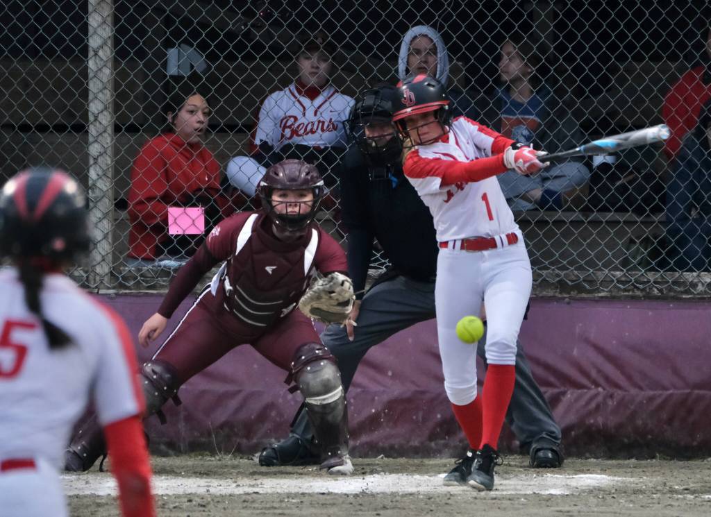 Juneau-Douglas High School: Yadaa.at Kalé senior Zoey Billings (1) and Ketchikan senior catcher Faith Easterly watch a single begin during the Crimson Bears and Lady Kings tie on Thursday at Melvin Park. (Klas Stolpe / Juneau Empire)