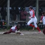 Juneau-Douglas High School: Yadaa.at Kalé junior Mila Hargrave (8) is safe at first as Ketchikan junior Rylie Welk misses the ball during the Crimson Bears and Lady Kings tie on Thursday at Melvin Park. (Klas Stolpe / Juneau Empire)