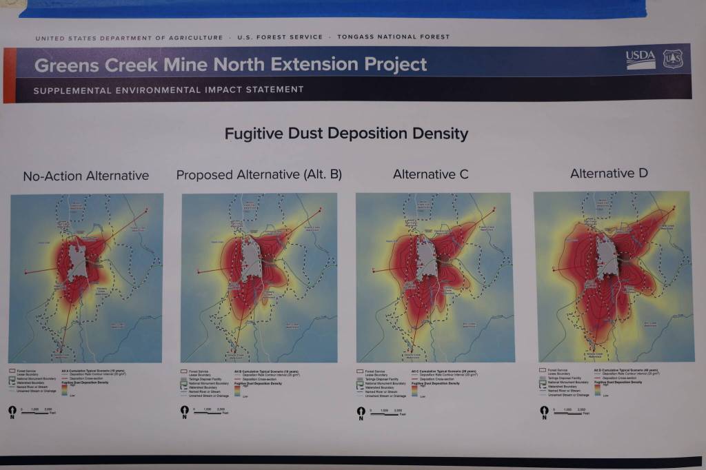 This is a picture of a poster that was hung on the wall of the Angoon city community center Friday afternoon during a meeting about the four alternatives for the Hecla Greens Creek Mine North Extension Project. The poster outlined the fugitive dust deposition density of each proposal, including the no-action alternative. (Clarise Larson / Juneau Empire)