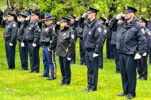 Members of the Juneau Police Department stand at attention to honor fallen officers on Friday during the Alaska Peace Officers Associations annual memorial service at Evergreen Cemetery. (Jonson Kuhn / Juneau Empire)