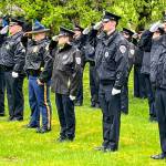 Members of the Juneau Police Department stand at attention to honor fallen officers on Friday during the Alaska Peace Officers Associations annual memorial service at Evergreen Cemetery. (Jonson Kuhn / Juneau Empire)