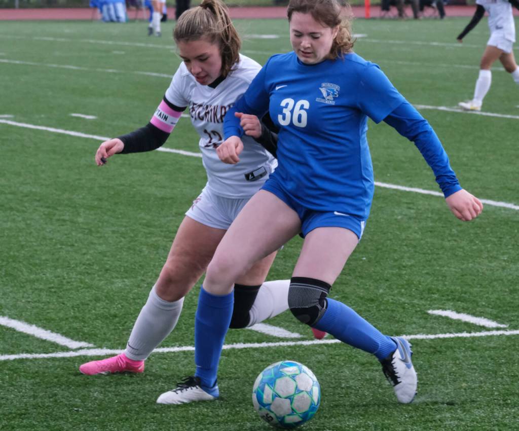 Ketchikans Katey Isner (12) and Thunder Mountains Kaidree Hartman (36) battle during soccer action Friday at Falcons Field. (Klas Stolpe / Juneau Empire)