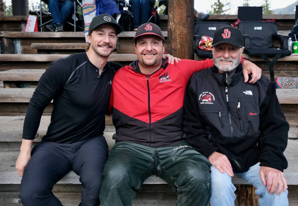 Dylan Baker, Chad Bentz and Jim Ayers pose for a photo at Adair Kennedy Field after the announcement of naming the soon to be built Crimson Bears baseball dugout after former coaching staff member Frank Barthel who passed in 2022. (Klas Stolpe / Juneau Empire)