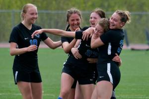 Thunder Mountain senior Mackenzie Olver (27) celebrates with (from left) senior Kaelin Tibbles (10), junior Adella Dihle, junior Kaidree Hartman and junior Zoey Moore after scoring against Ketchikan on Saturday at Falcons Field. (Klas Stolpe / Juneau empire).