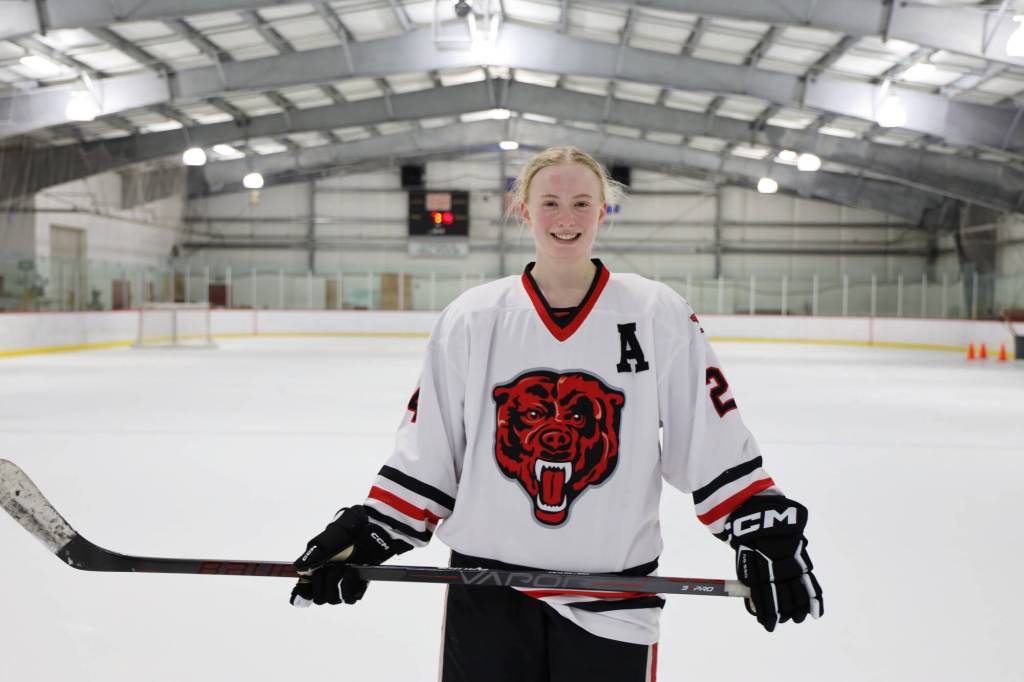Anna Dale, a senior and the Juneau-Douglas High School: Yadaa.at Kalé Crimson Bears Varsity hockey team assistant captain smiles on the ice after a January practice. On Monday, Dale signed a national letter of intent to play hockey at Lebanon Valley College. (Clarise Larson / Juneau Empire File)