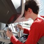 Eugene Rehfield, 10, controls the Da Vinci Xi Robotic Surgery System as he attempts to unwrap a Starburst while attending the open house celebration of the machine at the Bartlett Regional Hospital lobby Monday evening. (Clarise Larson / Juneau Empire)