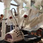 Residents and Bartlett Regional Hospital officials surround the Da Vinci Xi Robotic Surgery System on display at the hospitals lobby during an open house even for the machine Monday evening. (Clarise Larson / Juneau Empire)