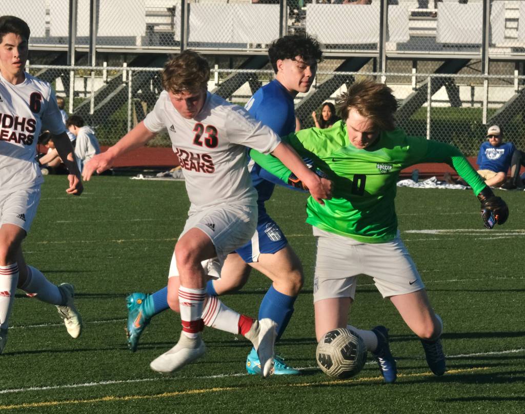 JDHS senior Gabe Cheng (6) and Micah Brown (23) battle Thunder Mountain senior MJ Tupou and junior keeper Corbin Carson during the Crimson Bears 6-1 win over the Falcons Tuesday at Falcons Field. (Klas Stolpe / Juneau Empire)