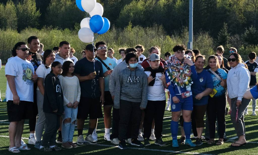 Thunder Mountain senior MJ Tupou with family and friends during the Falcons boys soccer senior recognition Tuesday at Falcons Field. (Klas Stolpe / Juneau Empire)