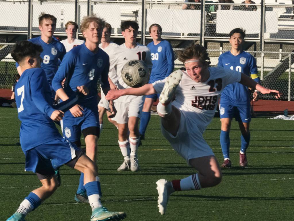 JDHS senior Micah Brown (23) plays a ball in the air during the Crimson Bears 6-1 win over the Thunder Mountain Falcons Tuesday at Falcons Field. (Klas Stolpe / Juneau Empire)