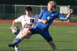 JDHS sophomore Kellen Chester (10) and TMHS senior Matthew Spratt (4) battle for a ball during the Crimson Bears 6-1 win over the Falcons Tuesday at Falcons Field. (Klas Stolpe / Juneau Empire)