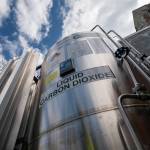 A liquid carbon dioxide containment unit stands outside the fabrication building of Glenwood Mason Supply Company, April 18, 2023, in the Brooklyn borough of New York. The Biden administration announced on Wednesday, May 17, $251 million for carbon capture and storage projects in seven states. (AP Photo / John Minchillo)