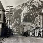 By 1914, when this photo was taken, Juneau had developed into an established city. The Victorian era turreted Alaska Steam Laundry (built 1901) is seen on the left, while other buildings such as the Alaskan Hotel and Central Rooming House are on the right. The rooming house was reconstructed in the 1980s. It is now the Senate Mall. (Alaska State Library-P31-021).