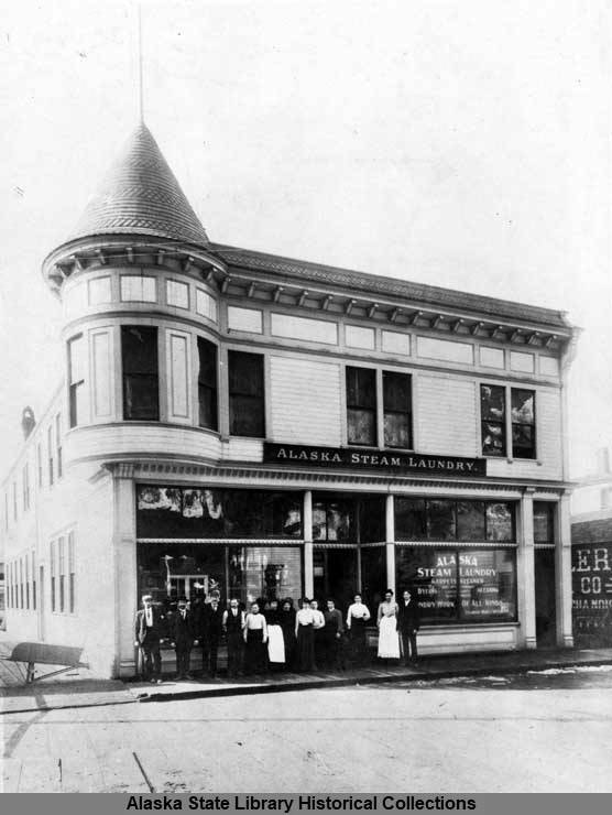 The turreted Alaska Steam Laundry was built in 1901. In this undated early photo, people gather on the wooden sidewalk adjacent to the wood planked street. The late Victorian era building stands today in Juneaus Downtown Historic District. In 1978 it was listed on the National Register of Historic Places. (Alaska State Library Historical Collections, Juneau Laundries-05, Neg. 01-1173)