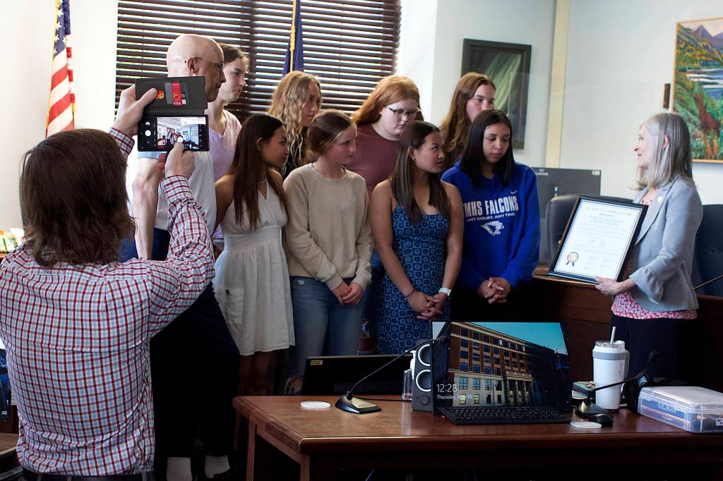 State Rep. Andi Story, D-Juneau, presents a citation to members of the Thunder Mountain High School womens basketball team during their visit to the Alaska State Capitol on Thursday, which was also the first and only day of a special session called by Gov. Mike Dunleavy due to a legislative stalemate over the budget. (Mark Sabbatini / Juneau Empire)