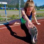 Thunder Mountain High School senior Mallory Welling stretches before a Falcons track practice on Wednesday. The Region V Track & Field Championships are Friday and Saturday at Falcons Field. (Klas Stolpe / Juneau Empire)
