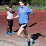 Thunder Mountain sophomore Kerra Baxter runs through a jump as Falcons coach Dwayne Duskin and sister Cailynn Baxter check her mark during Falcons track practice Wednesday. (Klas Stolpe / Juneau Empire)