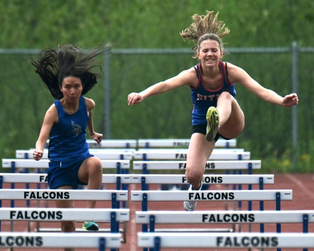 Sitka freshman Natalie Hall and Petersburg senior Alexus Sakamoto Quezon race a preliminary hurdle during the Region V Track & Field Championships, Friday, at Thunder Mountain. The championships resume Saturday. (Klas Stolpe / Juneau Empire)