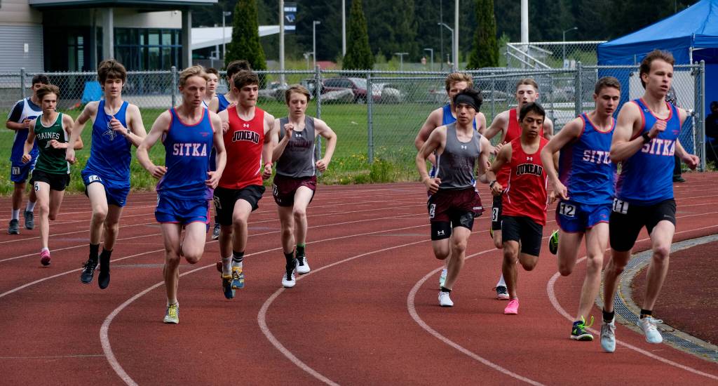 Runners round the first turn in the boys combined DI/DII 3200 meters during the Region V Track & Field Championships, Friday, at Thunder Mountain. The championships resume Saturday. (Klas Stolpe / Juneau Empire)