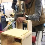 Craig senior Seth McClurgv making the bentwood box and sanding it under the Eagle totem of reused parts that is erected outside the schools shop in Yakutat for this years Alaska Student Activities Associations Region V Art Fest. (Courtesy Photo / Heather Ridgway)