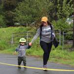 Callan, 2, and his mom Kate Foster run to the finish line during the Alaska Law Enforcement Torch Run at Twin Lakes Park Saturday morning. (Clarise Larson / Juneau Empire)