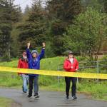 Fu Bao Hartle celebrates before crossing the finish line alongside Clare Pavia during the Alaska Law Enforcement Torch Run at Twin Lakes Park Saturday morning. (Clarise Larson / Juneau Empire)