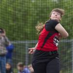 Maddy Wagner, a Gustavus junior, watches the discus fly 81 feet and 6.5 inches Saturday at Thunder Mountain High School. Wagner came in third place for Division II girls in the event during the Region V Track & Field Championships.