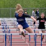 Thunder Mountain High School senior Mallory Welling leads the field enroute to winning the girls 100 meter hurdles during the Region V Track & Field Championships, Saturday, at TMHS. From left: Ketchikan junior Linnea Loretan, Welling, Juneau-Douglas junior Hannah Brennell and JDHS freshman Isabella Reyes-Boyer. (Klas Stolpe / Juneau Empire)