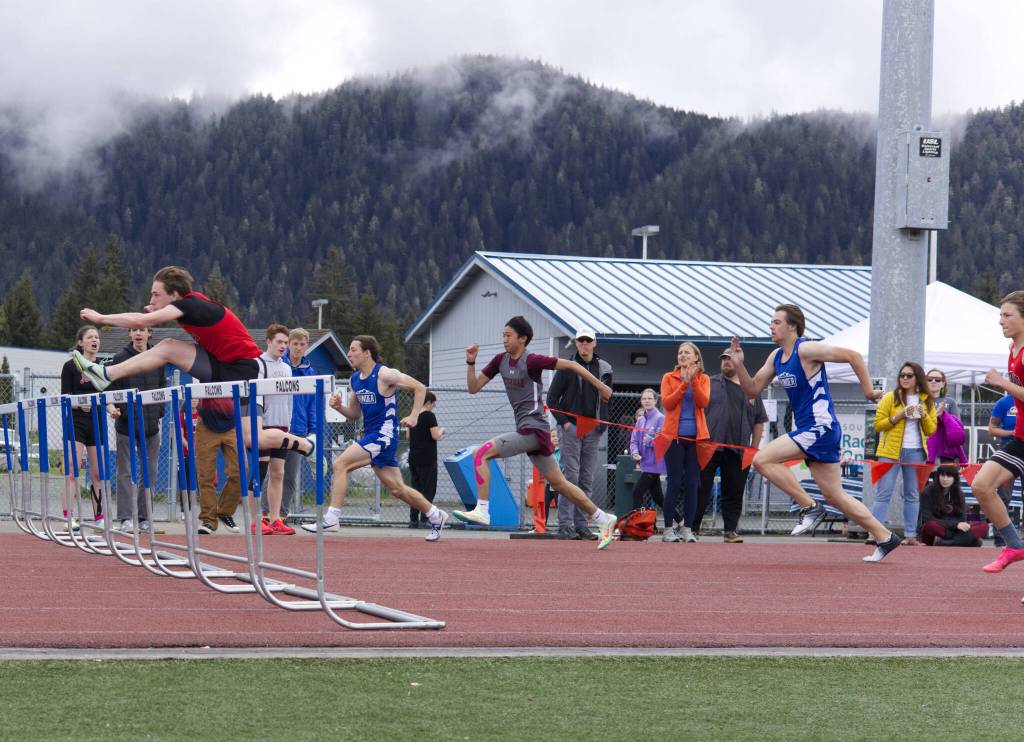 Division I boys hurdlers race to the finish line Saturday during the Region V Track & Field Championships held at Thunder Mountain High School. JDHS Caden Johns took the top spot in the 110-meter hurdles with a time of 17.24 seconds. TMHS Finley Hightower and Gunnar Tarver rounded out the top three spots in the race. (Ben Hohenstatt / Juneau Empire)