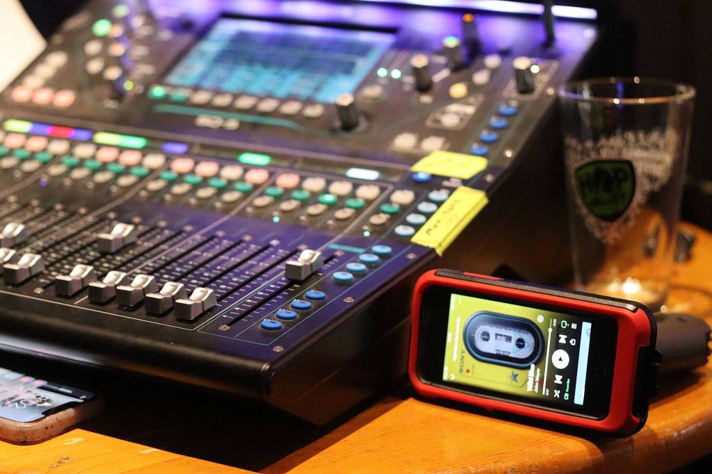 A virtual Sony Walkman plays a backing track cassette during a performance at the Amplify Alaska Fundraising Festival at Crystal Saloon on Saturday night. The evening featured a mix of live in-person and online elements, and was livestreamed in an effort to expand its fundraising reach. (Mark Sabbatini / Juneau Empire)