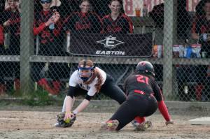 Thunder Mountain junior third baseman Jack Lovejoy attempts to tag Juneau-Douglas senior base runner Amira Andrews during softball action Saturday at Melvin Park. Andrews was out on the play. (Klas Stolpe / Juneau Empire)