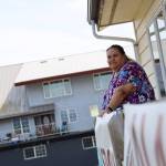 Award-winning Juneau writer Vera Starbard stands on her balcony on Douglas Island that displays banners across Gastineau Channel in support of the Writers Guild of America union strike currently going on across Hollywood and the country. (Clarise Larson / Juneau Empire)