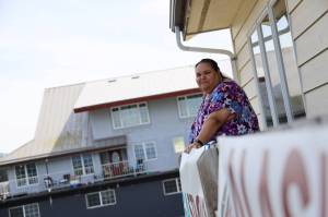 Award-winning Juneau writer Vera Starbard stands on her balcony on Douglas Island that displays banners across Gastineau Channel in support of the Writers Guild of America union strike currently going on across Hollywood and the country. (Clarise Larson / Juneau Empire)