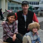 Sayéik: Gastineau Community School physical education teacher Dirk Miller poses with Nevaea Johnson and Nolan Seris during a Field Day break at the school Thursday. Miller is retiring after 24 years at the school. (Klas Stolpe / Juneau Empire)