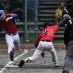 Sitka senior Dylan Marx is put out at first base by Juneau-Douglas High School: Yadaa.at Kalé senior Bodhi Nelson during the Wolves 9-2 win over the Crimson Bears during the Region V Baseball Tournament, Friday, at Adair Kennedy Field. (Klas Stolpe / Juneau Empire)