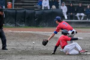 Juneau-Douglas High School: Yadaa.at Kalé base runner Finn Kesey steals second base as Sitkas Brett Ross awaits the throw and base umpire Keith Perkins watches the action during the Wolves 9-2 win over the Crimson Bears during the Region V Baseball Tournament, Friday, at Adair Kennedy Field. (Klas Stolpe / Juneau Empire)