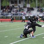 Team Juneaus Steve Lewis, JDHS Class of 1998, holds the ball for teammate Mahina Toutaiolepo, TMHS class of 2017, whose foot put the first 3 points of the 2023 Alumni Game Friday night at Adair-Kennedy Memorial Field. (Ben Hohenstatt / Juneau Empire)