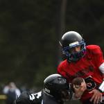 Team World player and 2018 Thunder Mountain High School graduate Jacob Tapia holds tight to the ball while running down the field during the Juneau Alumni Football game on Friday at Adair-Kennedy Memorial Park. (Clarise Larson / Juneau Empire)
